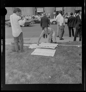 Protester making picket signs outside the Federal Building in Boston during sentencing of the "Boston Five"