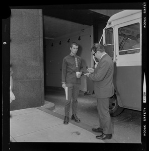 Two unidentified men, one possibly a protester and one possibly a reporter, outside the Federal Building in Boston during sentencing of the "Boston Five"