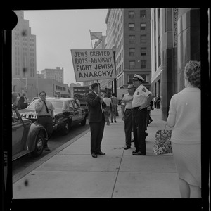 Josef Mlot-Mroz holding sign outside the Federal Building in Boston during protests after the sentencing of Dr. Spock and the other "Boston Five" on draft conspiracy charges