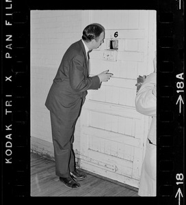 Dr. Robert Mezer speaks through a cell door with a patient at Bridgewater State Hospital