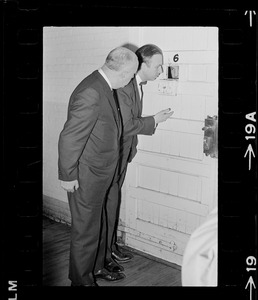 Paul A. Tamburello and Dr. Robert Mezer speaks through a cell door with a patient at Bridgewater State Hospital