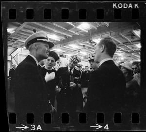 Rear Admiral Percival Jackson, two unidentified people, Captain Melvin Etheridge, and Massachusetts Secretary of State Kevin White on the USS Wasp