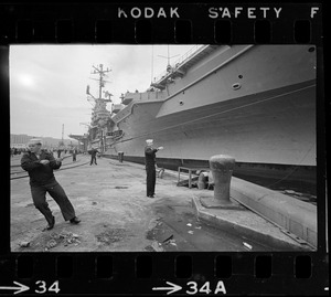 Sailors working on dock next to USS Wasp