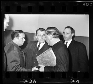 John Asgeirsson, unidentified man, F. Lee Bailey, Paul Smith, and Robert Barton conferring outside Massachusetts Supreme Court chambers after hearing about the Boston Strangler