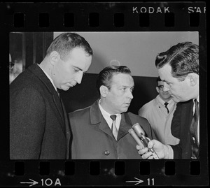 Robert Barton and an unidentified man being interviewed by reporter outside Massachusetts Supreme Court chambers after hearing about the Boston Strangler