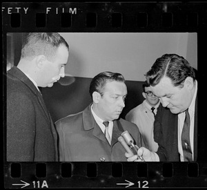 Robert Barton and an unidentified man being interviewed by reporter outside Massachusetts Supreme Court chambers after hearing about the Boston Strangler