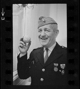 Unidentified man in Marine Corps League uniform holding autographed baseball