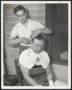 But not from Joe Louis. Jack says he'll trim Joe tonight just as neatly as Terry Parker is trimming his hair in this picture.