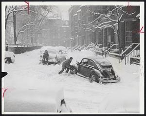 Pushing was the best way to get a car out of Louisburg Sq. today, with snow causing cars to skid into gutters.