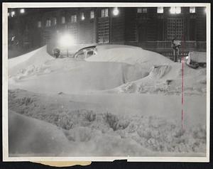 Drifting Snow almost covers this automobile in Park Square, only one of many cars that were useless in attempting to get through the heavy snowfall and drifts of yesterday's storm.