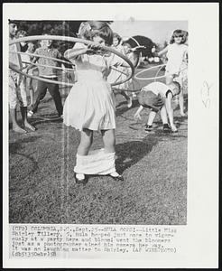 Hula Oops!--Little Miss Shirley Tillery, 5, hula hooped just once to vigorously at a party here and bloom! went the bloomers just as a photographer aimed his camera her way. It was no laughing matter to Shirley.