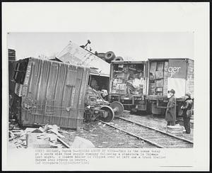 Chicago Storm Damage - Tossed about by a windstorm on Chicago's South Side, a box car and truck trailer, background, presented this picture. The tornado-like storm battered 30 square blocks near the University of Chicago.