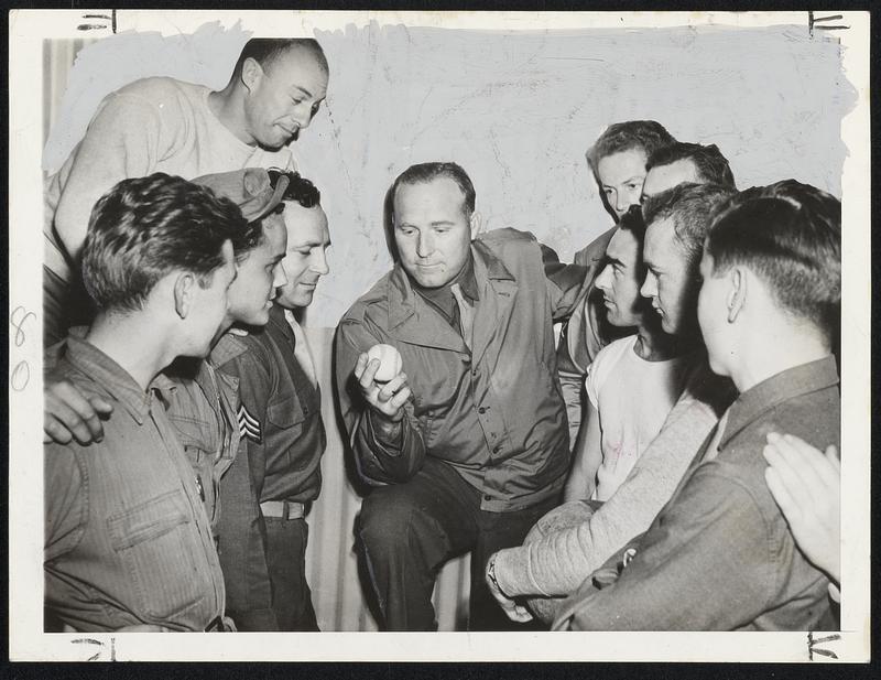 Ruffing's In The Army Now and he's showing the boys how he held the ball to pitch his slider when he was with Yankees. He's with the California group of the Ferrying Division Transport Comm