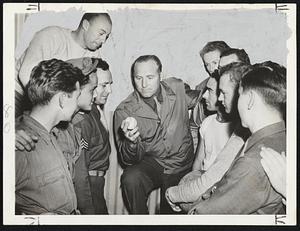 Ruffing's In The Army Now and he's showing the boys how he held the ball to pitch his slider when he was with Yankees. He's with the California group of the Ferrying Division Transport Comm