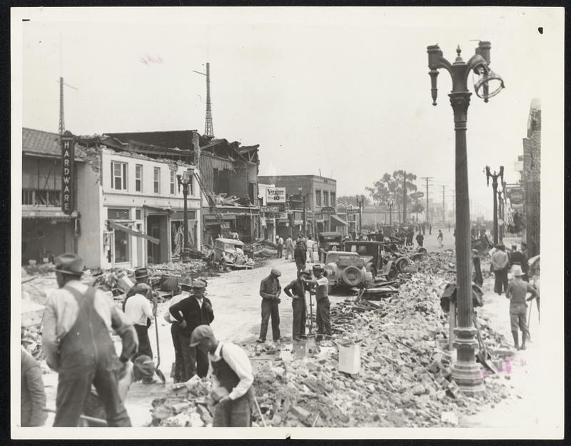 Compton Clears Main Street After Quake. Clearing away debris is on the Main Street of Compton, Calif., the day after the earthquake, March 10.