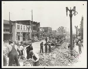 Compton Clears Main Street After Quake. Clearing away debris is on the Main Street of Compton, Calif., the day after the earthquake, March 10.