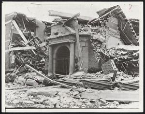 Effect of West Coast Earthquake in Long Beach. At lest sixty-five persons are believed to be dead and 1,000 injured. The city was apparently nearest the quake's epicenter. Major store and office buildings damaged in some degree and many small structures collapsed. This telephoto sent direct to New York from Los Angeles shows front of Jefferson Junior High School ruins.