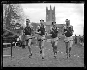 Four runners, Gasson Hall in background, Boston College
