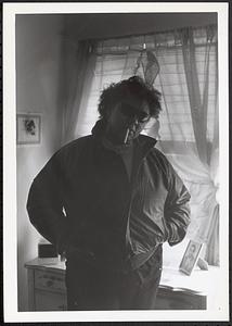 A woman posing in a jacket and sunglasses