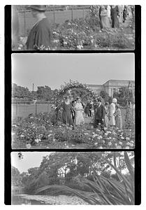 A group of people including Jesús Sanromá in a rose garden, Museum of Fine Arts in background