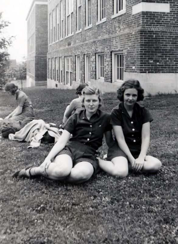 Two students sitting on lawn