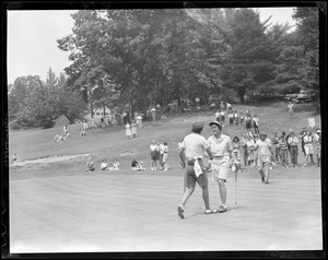 Mrs. Donald McCluskey congratulates smiling champion Pippy Rooney on 18th green at Pine Brook, State finals