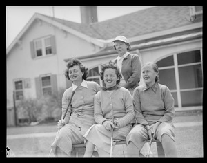 Four women pose in front of club house