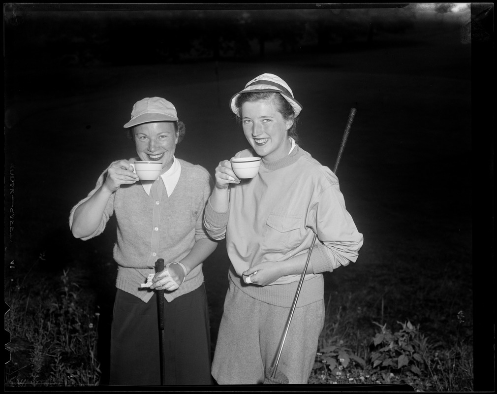 Two women sipping coffee on course