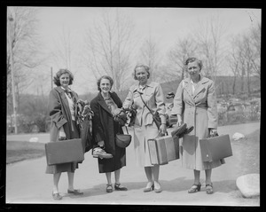 Four women dressed and packed to travel