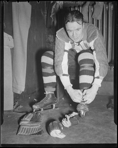 Mel Hill lacing his skates in Bruins locker room