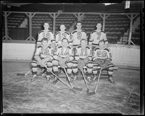 Boston Bruins players pose on ice