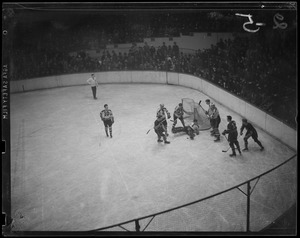 Bruins goalie, Tiny Thompson, stops shot in action around the net, Boston Garden