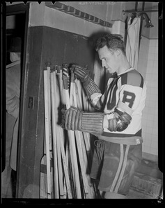 Bill Cowley of the Bruins selecting sticks at Boston Garden