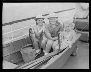 Three little girls in dory show their catch