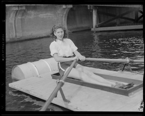 Woman rowing strange barge