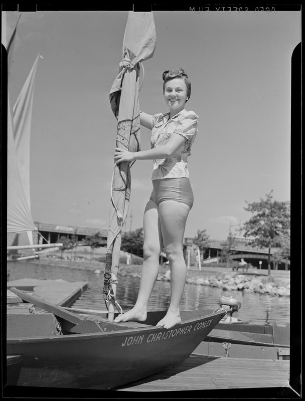 Young woman aboard sailboat "John Christopher Cowley"