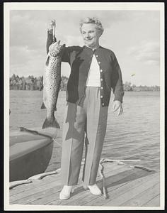 Unidentified person holds up a fish
