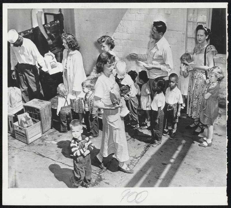 Emergency Milk Line--Doctors' certificates in hand, Washington parents and children line up at a South Capitol street dairy, set up to fill emergency needs as the district area milk strike continued. A quart a day for each child is the quota.