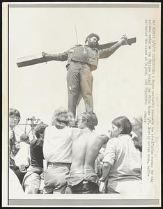 Washington: a Negro protestor reenact the crucifixion during the big antiwar rally on the Ellipse behind the White House 5/9. Shortly before noon, police estimated the crowd at 50,000.