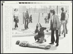 Death On the College Campus--A girl gestured and screamed as she knelt by the body of a student lying face down on the campus of Kent State University, Kent, Ohio, last May. National Guardsmen had fired into a crowd of demonstrators, killing four.