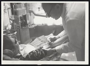 Dr. William Segal of Somerville administers a tranquilizer to one of his handicapped patients.