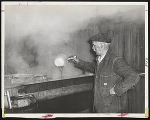 Maple Sugaring Time and Town Meetin' Time usually arrive together in New Hampshire. Henry Gowing, Dublin, N. H., checks the evaporating sap in his sugar house.