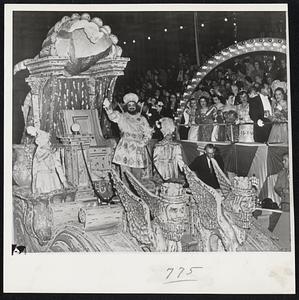 Parade Opens Carnival Week-The king of the Krewe of Babylon waves to carnival spectators at New Orleans as he passed in front of the reviewing stand during the parade with which Babylon, one of the older carnival organizations ushered in the 1952 carnival week merriment, which will be climaxed with Mardi Gras Day, the day before the beginning of Lent.