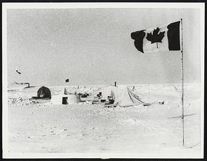 Arctic Weather Watchers. Washington: The World, the nations of Northern Hemisphere, stands in debt to the men--Canadians and Americans--who watch the weather from the five tiny, isolated stations deep in the Arctic, not far from the North Pole. Shown here, the Canadian flag blowing in the icy blast, is camp 200, far out on the permanently frozen Arctic Ocean, 250 miles from land, in 1967 file photo, These stations are operated jointly by the U.S. Weather Bureau and the Canadian government.