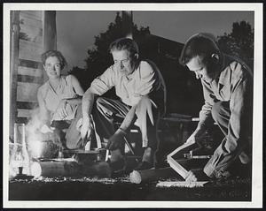 Cooking Out Is the Style since the hurricane snuffed out power, as in this Watertown scene last night. John K. Mason of Noblesville, Ind., shows his daughter, Mrs. George Murphy, left, and her husband, Dr. George Murphy of Massachusetts General Hospital how it's done out West. The Murphys live on Morrison Road.