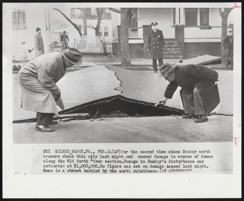 For the second time since Sunday earth tremors shook this city last night and caused damage to scores of homes along the Old North River section. Damage in Sunday's disturbance was estimated at $1,000,000. No figure was set on damage caused last night. Here is a street buckled by the earth subsidence.