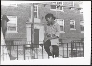 Young girl sitting on a railing
