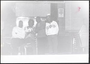 Group of young people, one holding a sneaker
