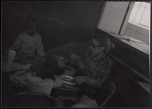 Man and two children sitting at a table