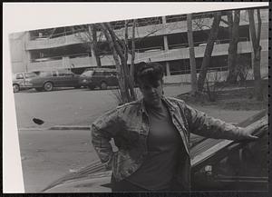 Anna posing next to a car
